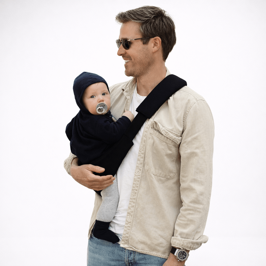 Toddler seated in sling carrier — NAEVII